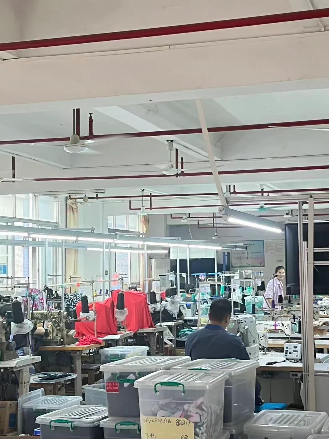 Swimwear sewing line with finished bikinis on display