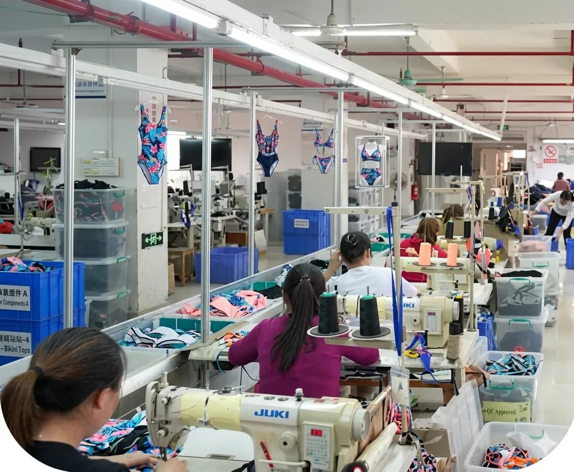 Close-up of seamstresses sewing swimwear